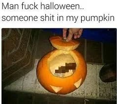 A person's hand lifts the lid of a carved jack-o'-lantern, revealing a pixelated, blurred substance inside that resembles…