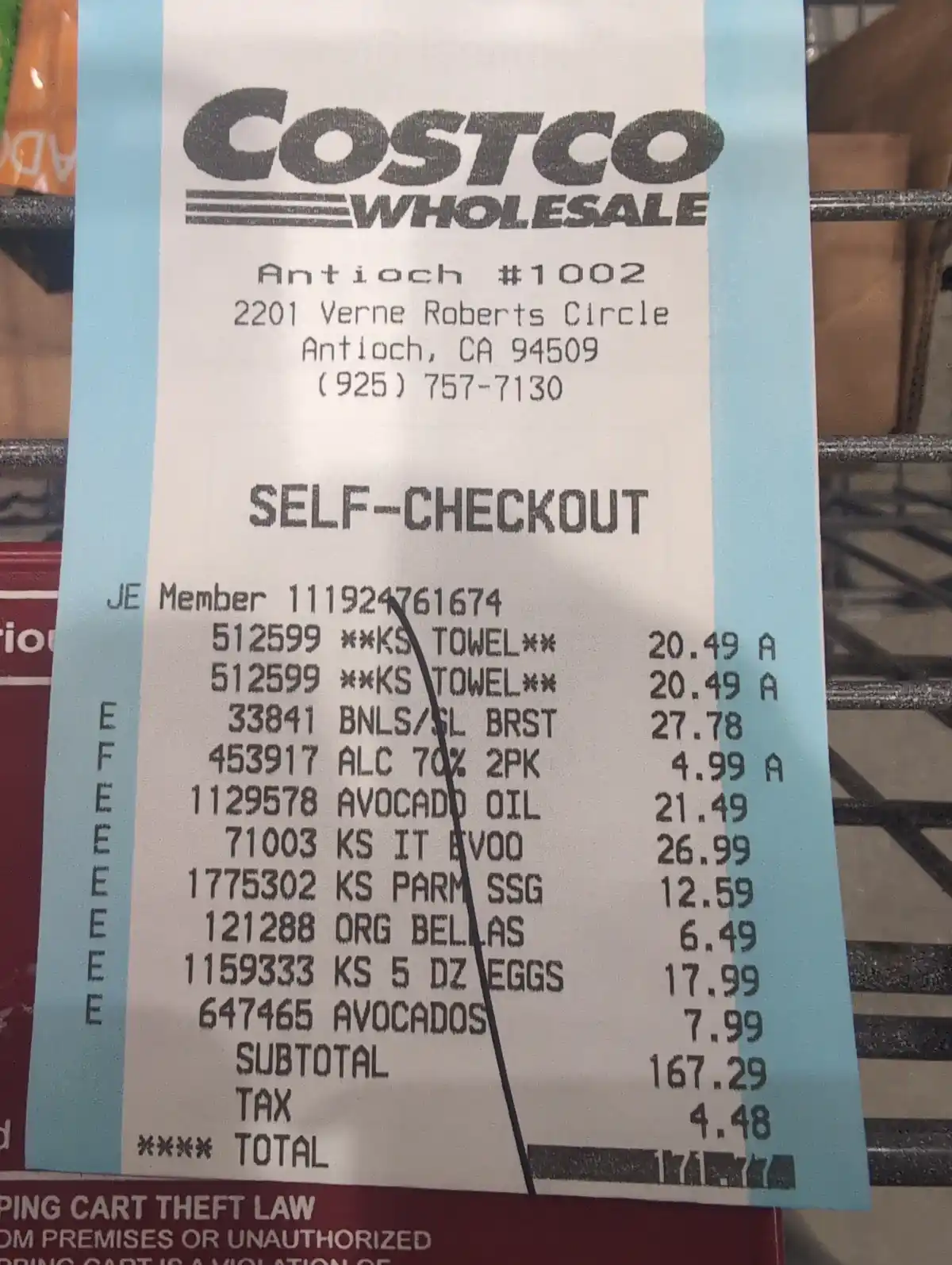 A Costco Wholesale self-checkout receipt from the Antioch store, showing items like towels, avocado oil, eggs, and avocados…