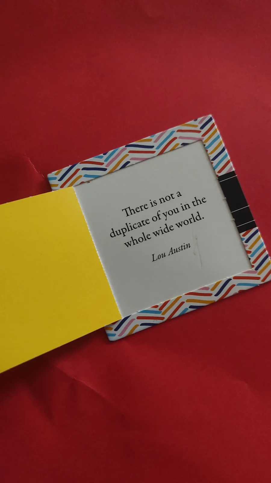 A close-up photo shows an open greeting card with a white interior panel displaying the quote 'There is not a duplicate of…