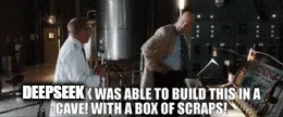 The image shows two men in a dimly lit, high-tech control room with complex machinery. One man, wearing a white shirt and…