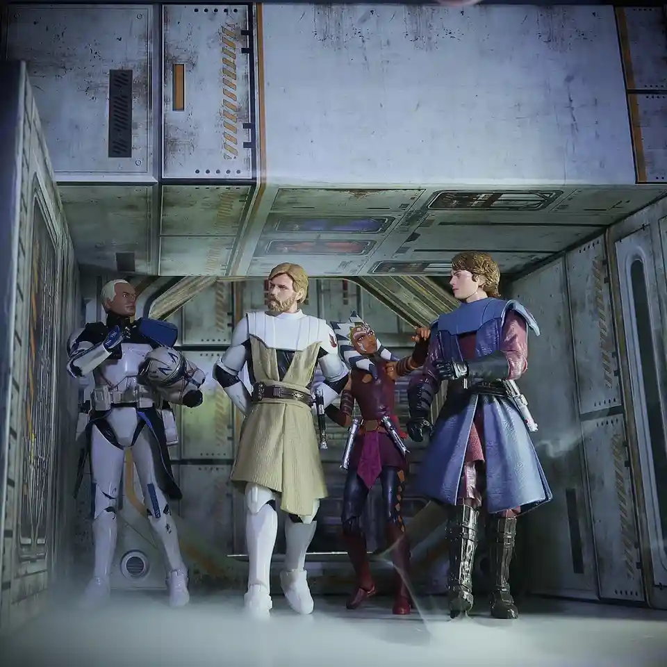 Four Star Wars action figures — a clone trooper, a Jedi in a beige robe, Ahsoka Tano, and Anakin Skywalker — stand in a…