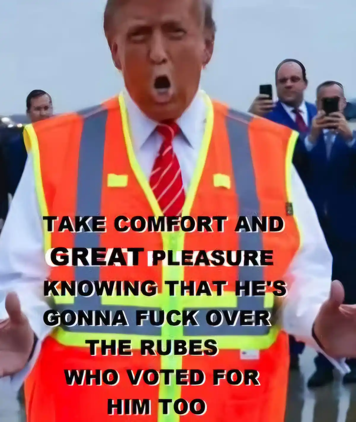 A man in an orange and yellow reflective safety vest with a red tie and white shirt has his mouth wide open in an expressive…