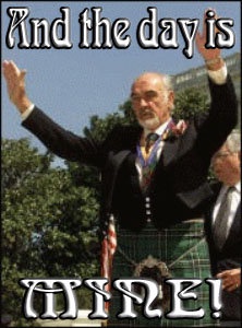 A man in a kilt and formal jacket stands outdoors with both arms raised in celebration. The image has bold, stylized text…