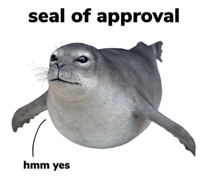 A gray seal is shown with a smug, satisfied expression, looking upward. Text at the top reads 'seal of approval,' and an…