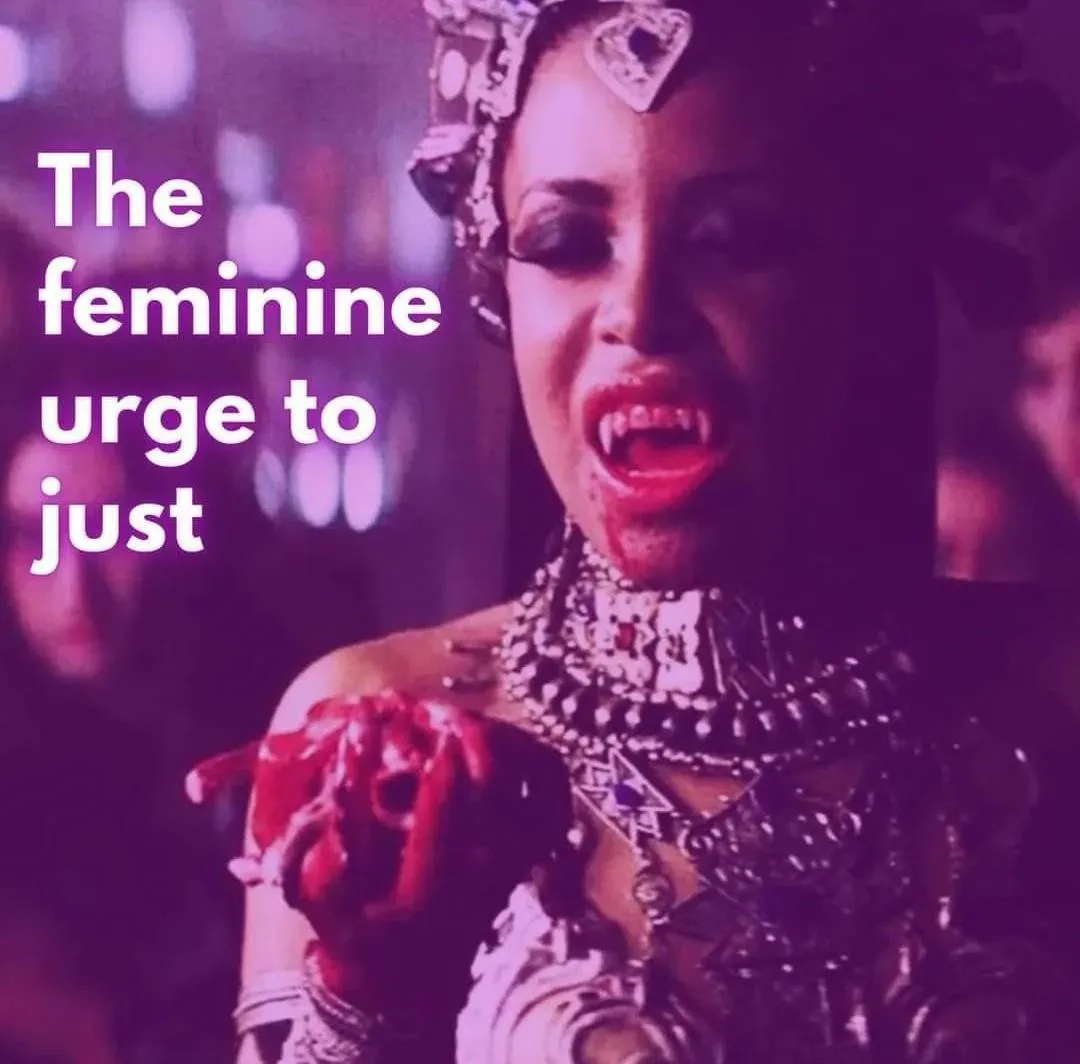 A woman with fangs, wearing ornate jewelry and holding a bloody rose, has text overlaid that reads 'The feminine urge to…