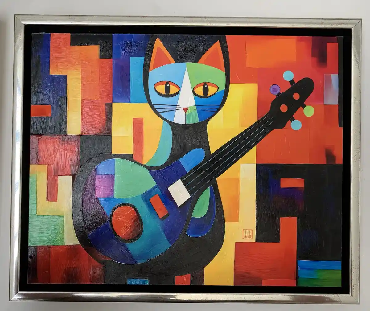 A framed abstract painting depicts a stylized black cat with a colorful, geometric face holding a similarly colorful guitar…