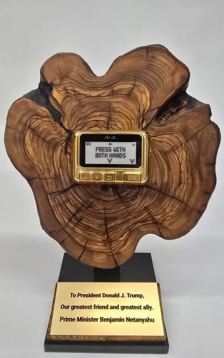 A gold-colored, old-style digital device with a screen displaying 'PRESS WITH BOTH HANDS' is mounted on a large, ornate…