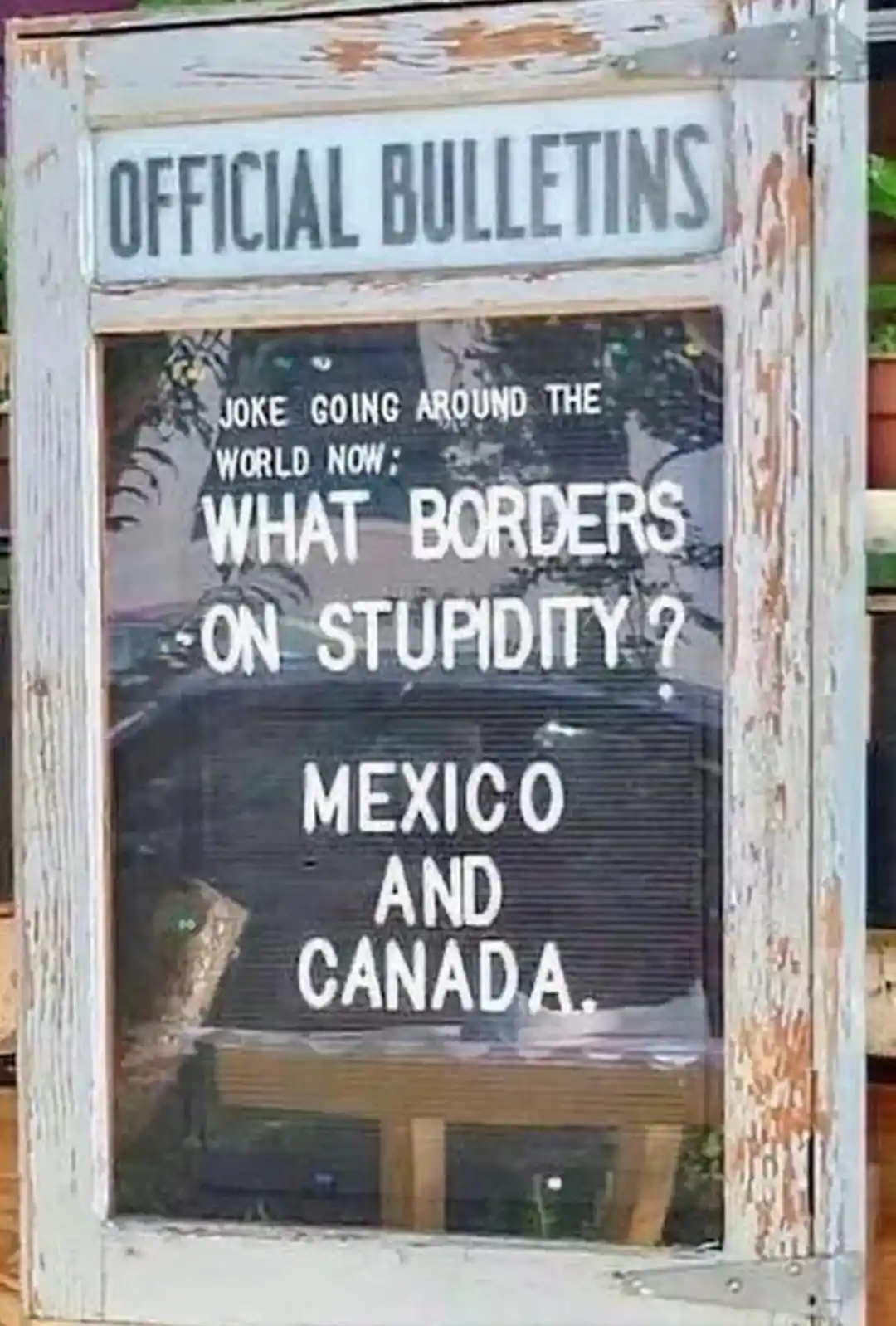 An image of a weathered wooden bulletin board labeled 'OFFICIAL BULLETINS' displays a joke on a letterboard inside. The text…