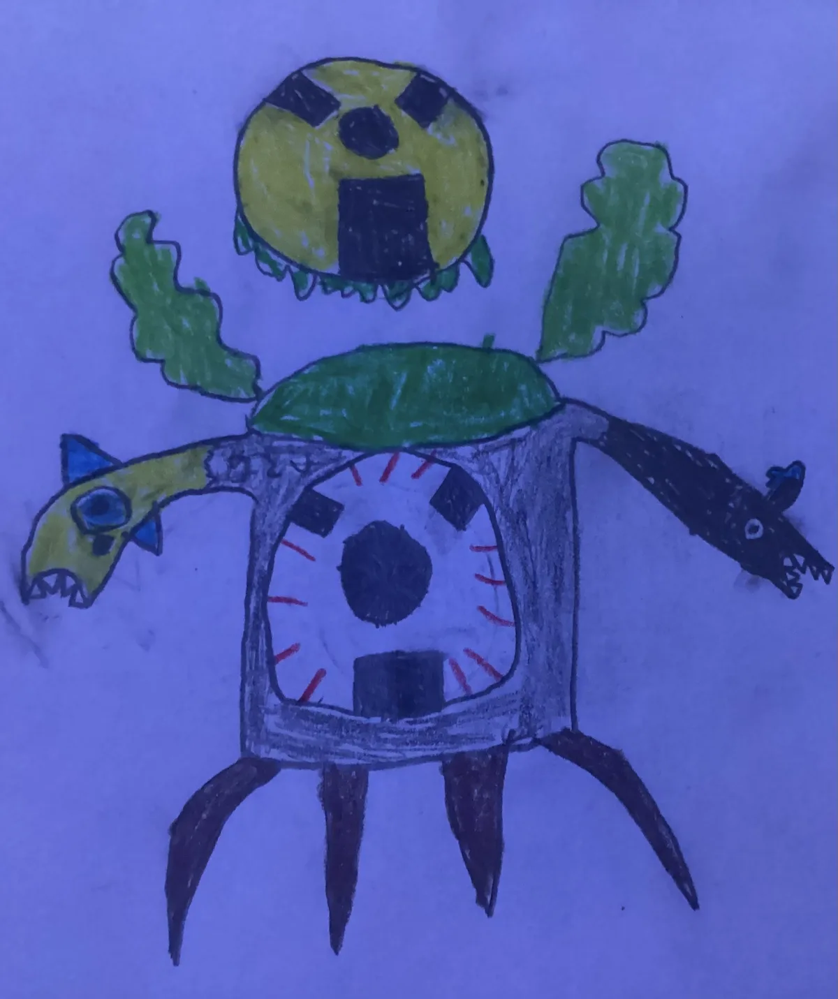 A child's crayon drawing depicts a monstrous creature with a yellow spherical head, green leaf-like arms, and a square body…