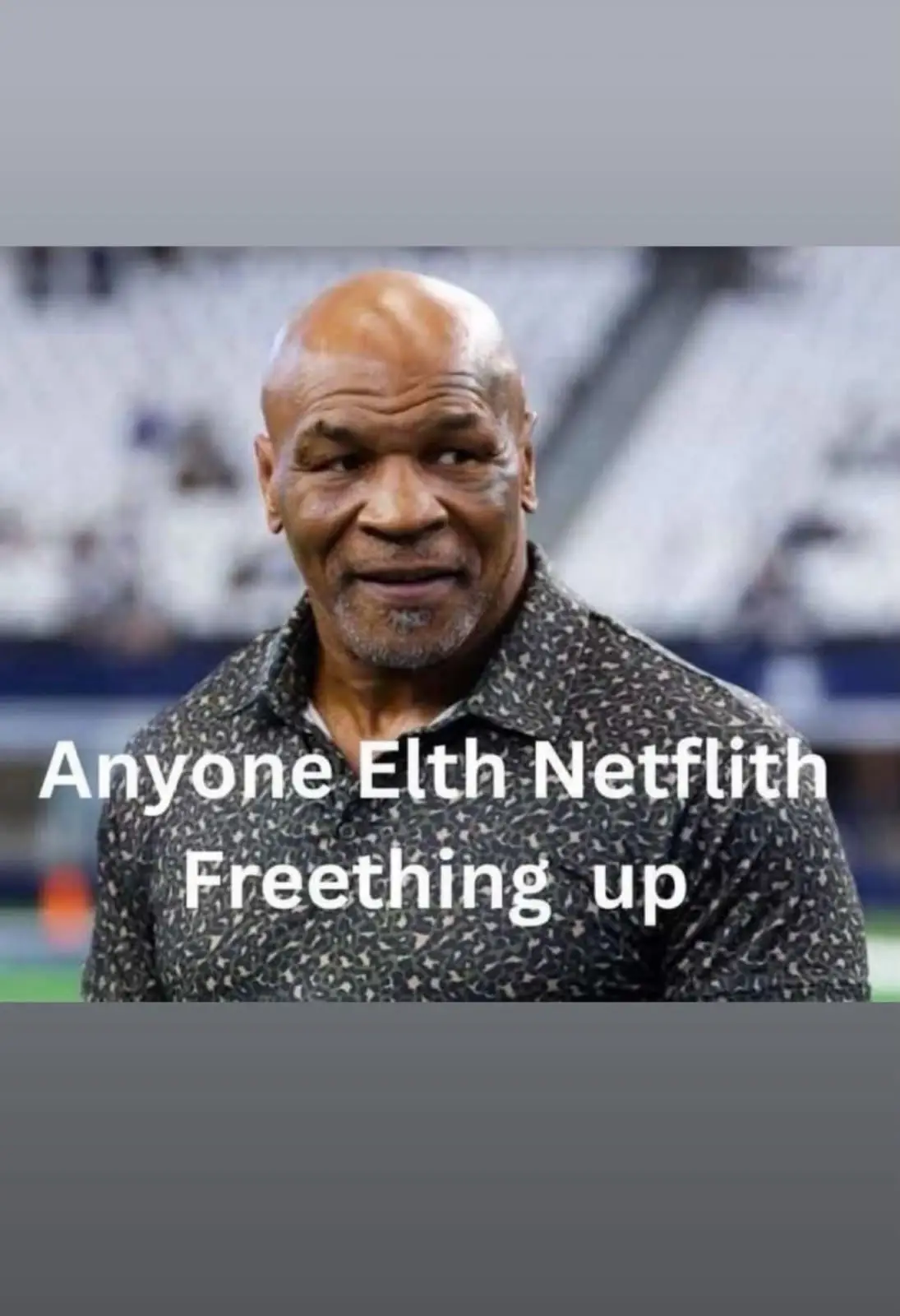 A photo of Mike Tyson looking sideways with a smirk, overlaid with the text 'Anyone Elth Netflith Freething up', which is a…