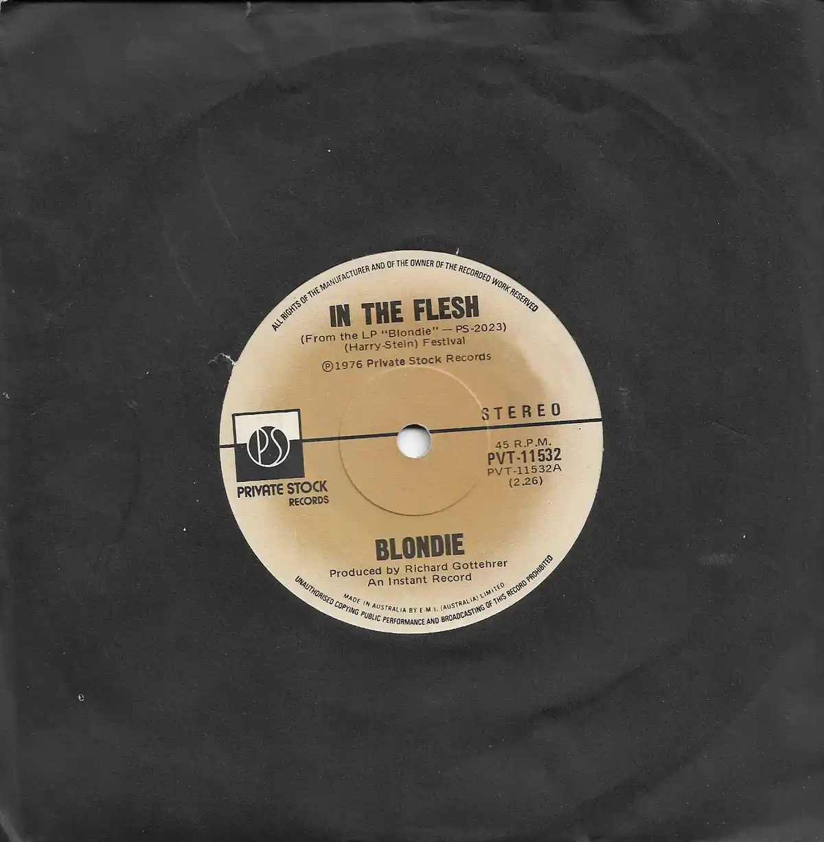 A close-up photo of a vintage 45 RPM vinyl record label for Blondie's song 'In The Flesh'. The beige label, set against a…