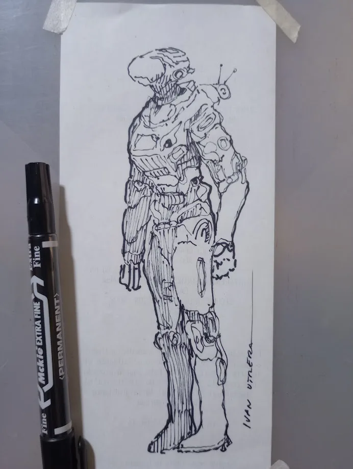 A black-and-white sketch of a heavily armored, futuristic humanoid robot with a helmet and mechanical limbs, taped to a wall…