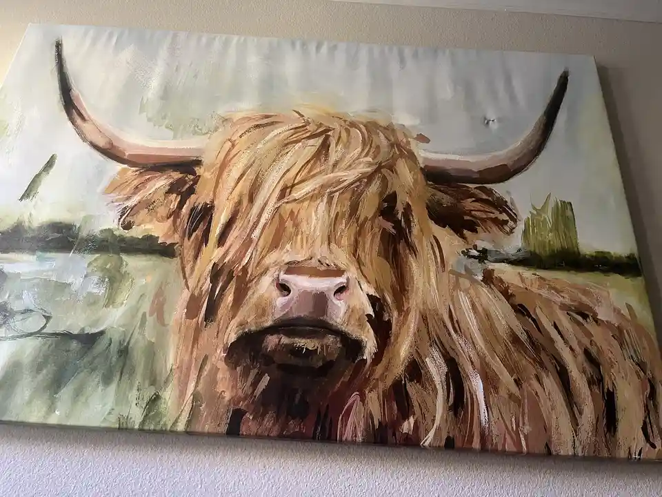A painting of a highland cow with long shaggy brown hair and large curved horns, looking directly at the viewer. The cow is…