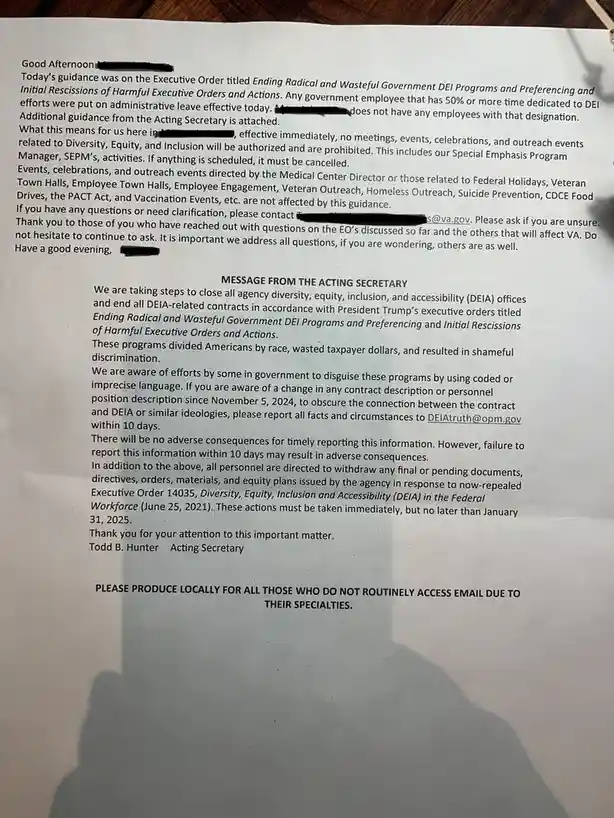 A printed government memo from the VA Acting Secretary about ending DEIA programs, with redacted names and a shadow of a…