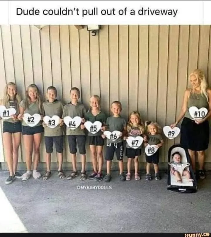 A family photo shows ten people standing in a line in front of a wooden wall, each holding a white heart-shaped sign with a…
