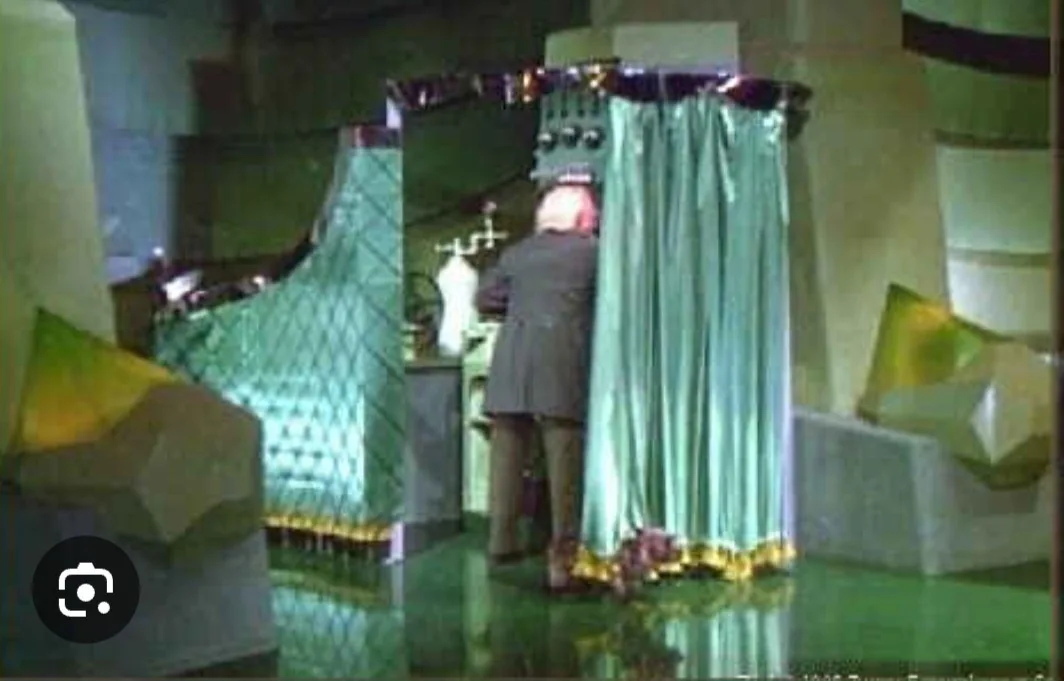A grainy, vintage-style image shows a person standing in front of a green shower curtain with a yellow trim, seemingly in a…