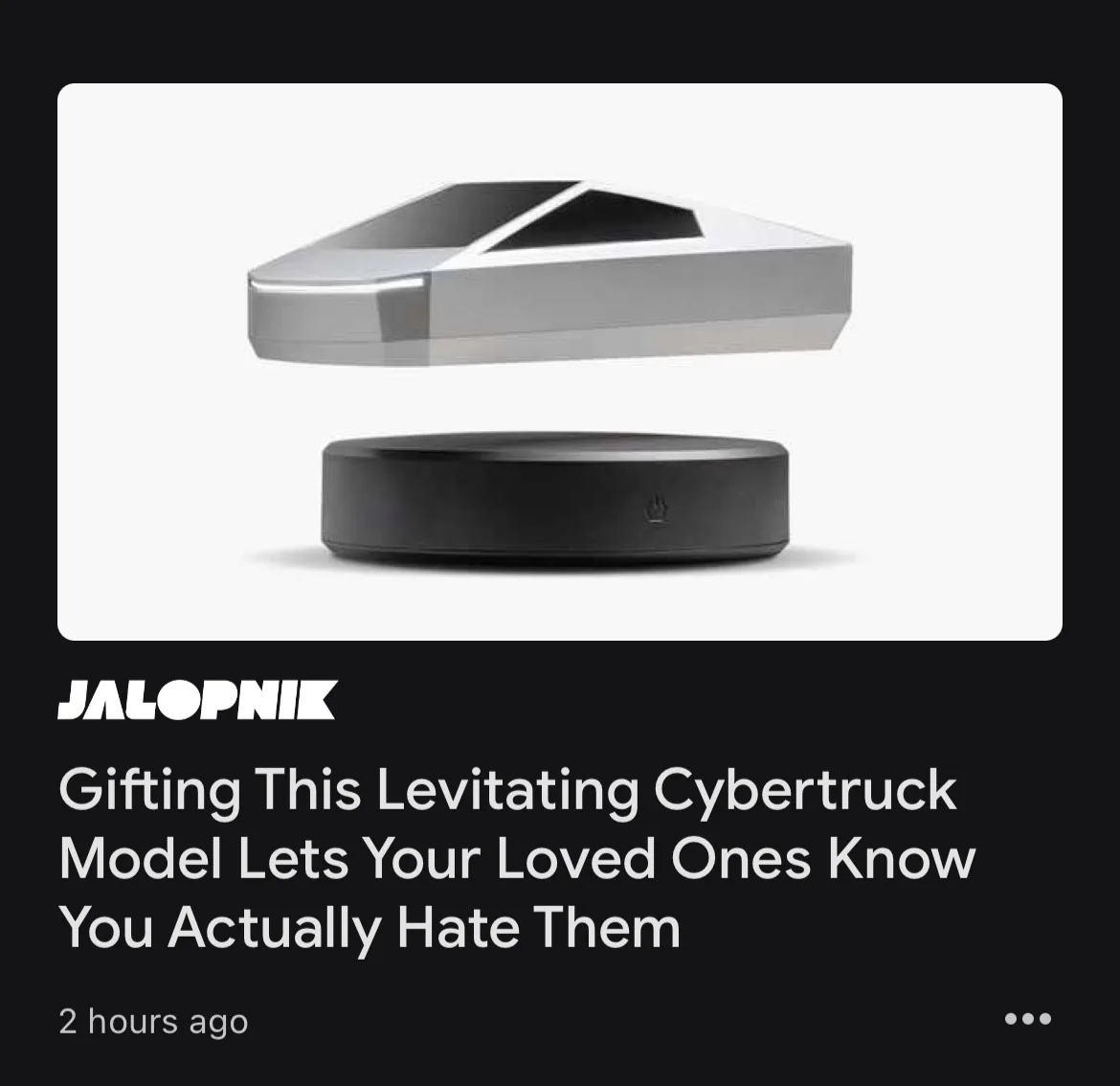 The image shows a small, silver, levitating model of a Cybertruck hovering above a black circular base. The overlaid text…
