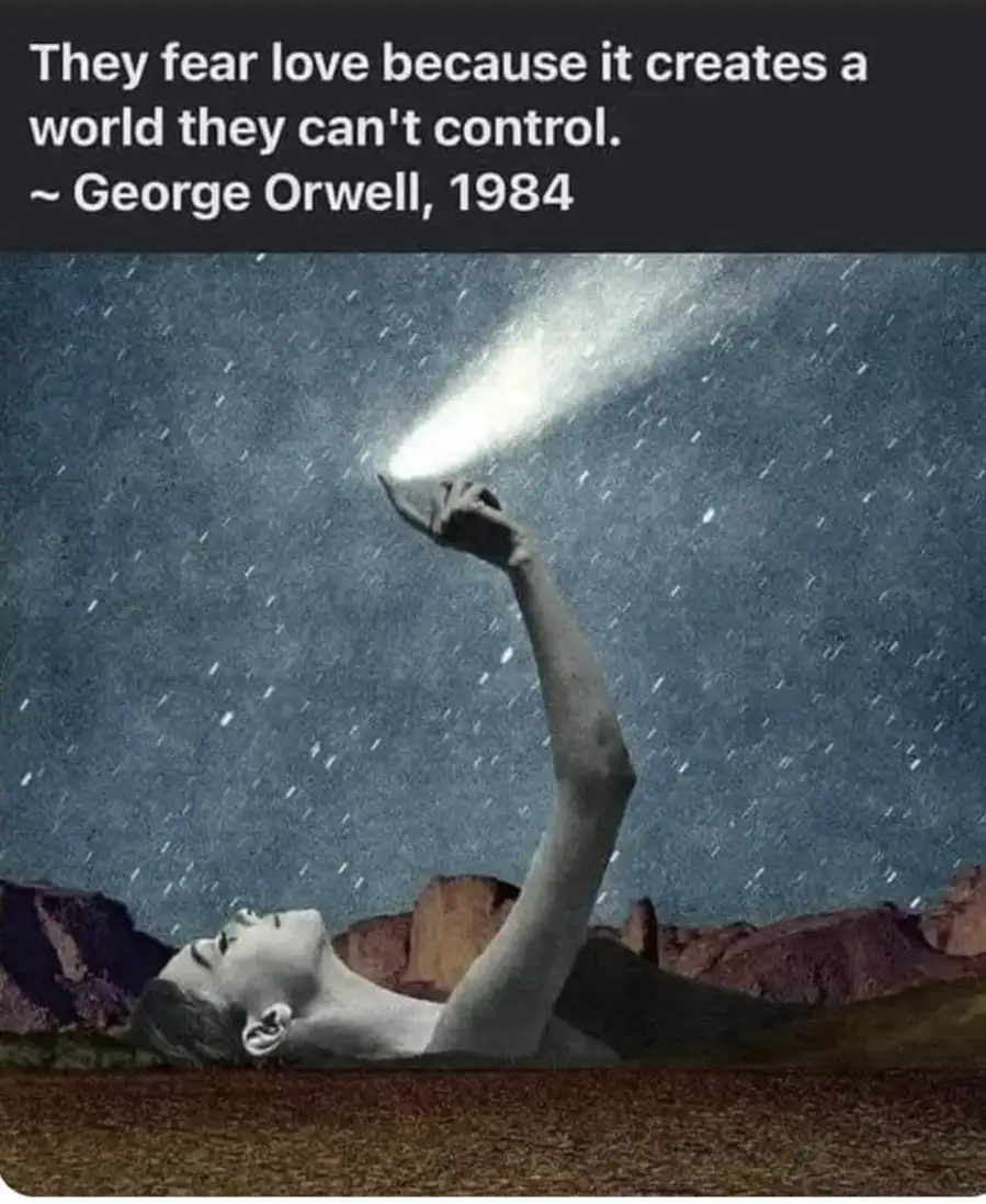 A person lies on their back in a desert-like landscape, reaching upward with one arm, holding a flashlight that beams a…