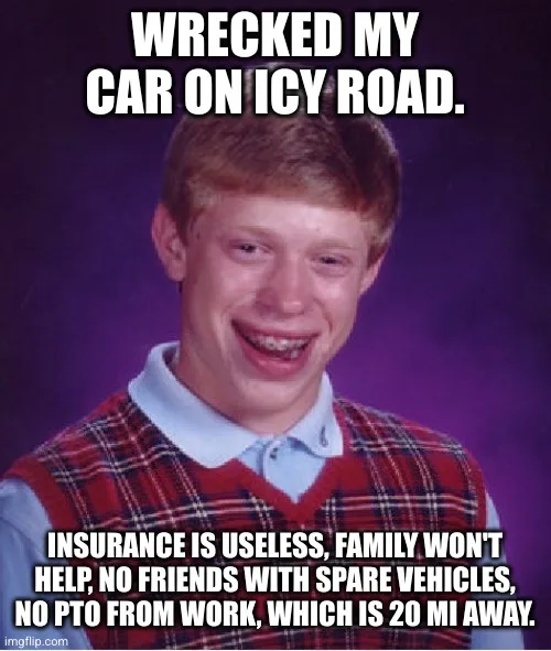 A young man with braces, wearing a red plaid vest over a light blue collared shirt, smiles awkwardly against a purple…