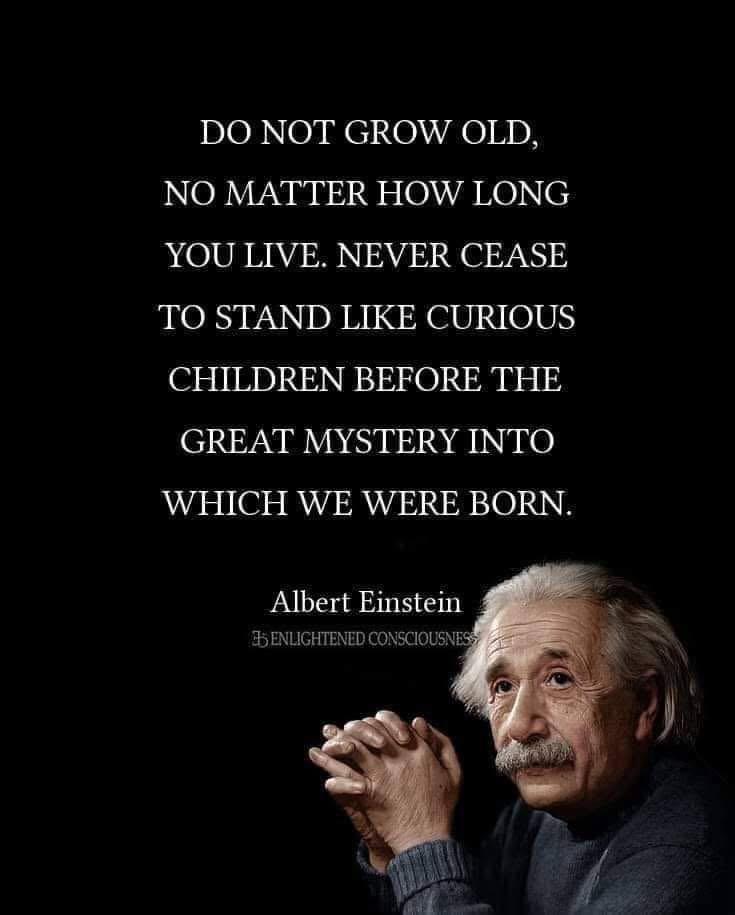 A black background features a portrait of Albert Einstein in the lower right corner, looking thoughtful with clasped hands…