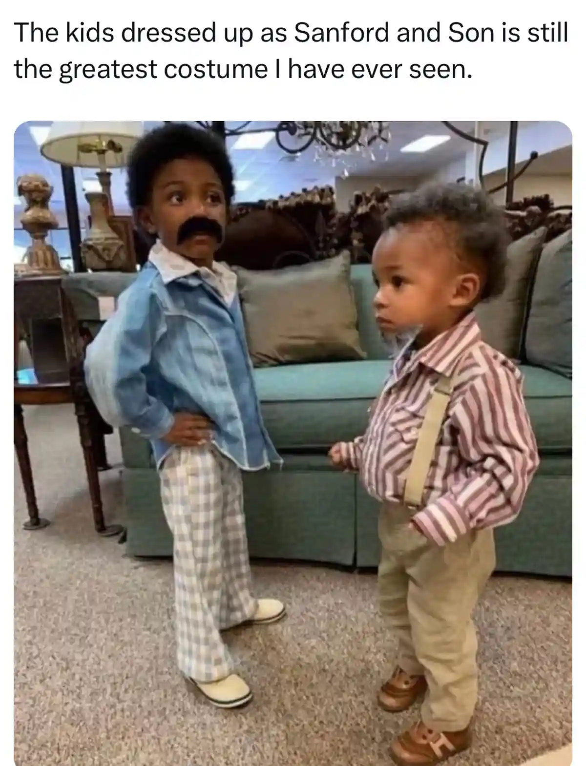 Two young Black boys stand indoors, dressed as characters from the TV show 'Sanford and Son'. The boy on the left wears a…