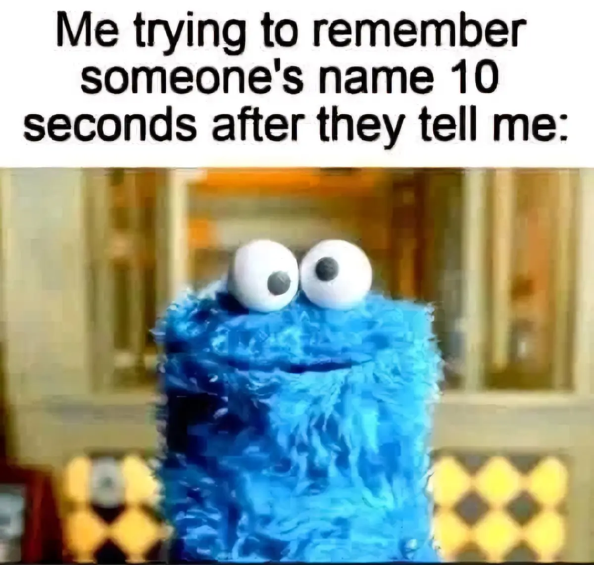 A still image of the blue, furry Cookie Monster puppet from Sesame Street, looking directly at the viewer with wide, round…