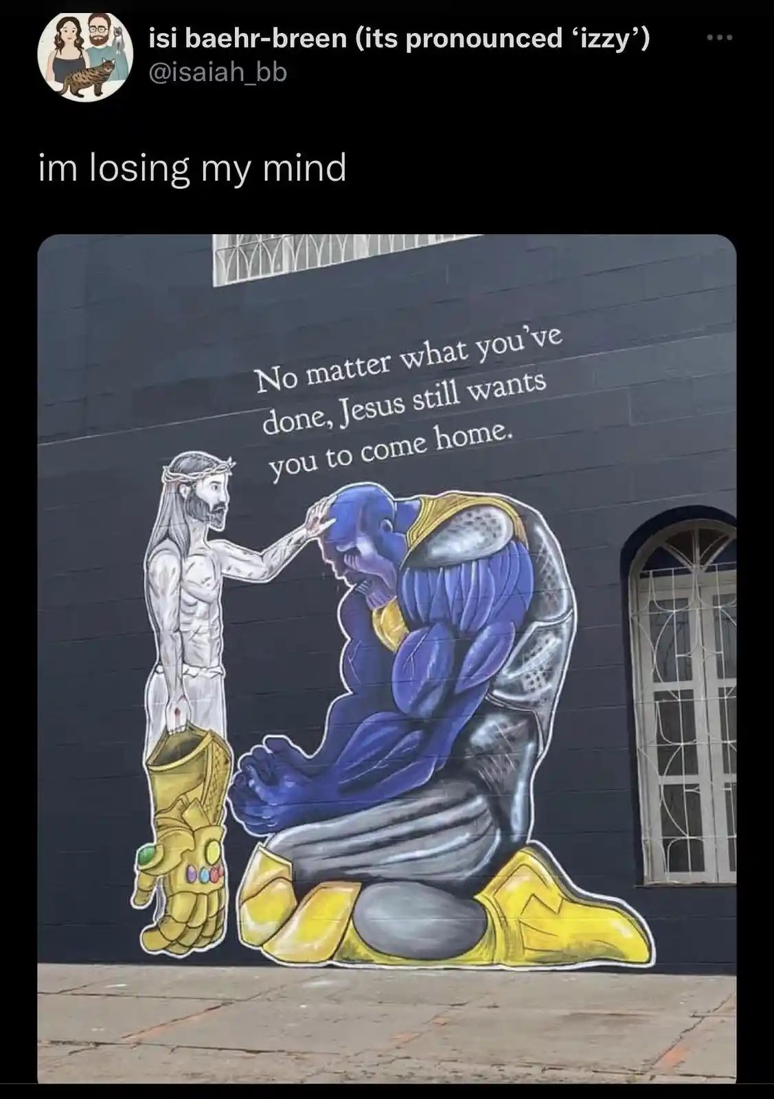 A mural depicts Jesus reaching out to comfort a kneeling Thanos, who is wearing his iconic Infinity Gauntlet. Above them…
