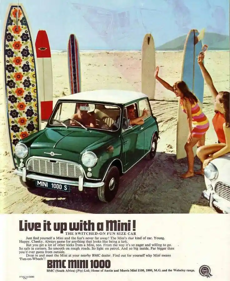 A vintage 1960s advertisement for the BMC Mini 1000, featuring a green Mini parked on a sandy beach with surfboards leaning…