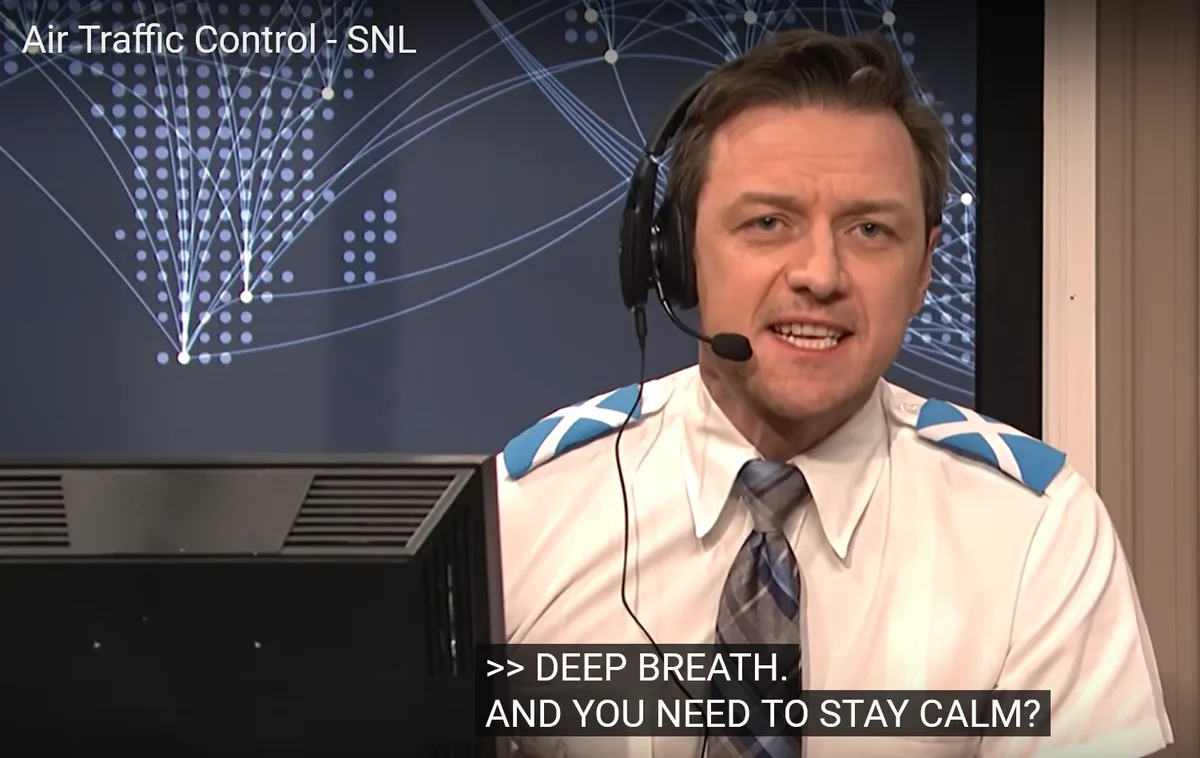 A man in an air traffic controller uniform with a headset, looking stressed, is shown in a scene from SNL. The text overlay…