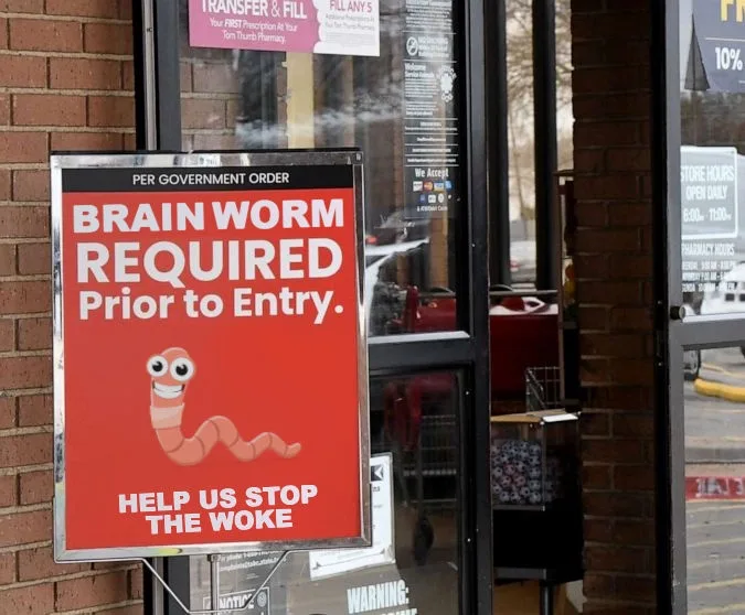 A red sign on a brick building's glass door reads 'PER GOVERNMENT ORDER BRAIN WORM REQUIRED Prior to Entry.' Below, a…
