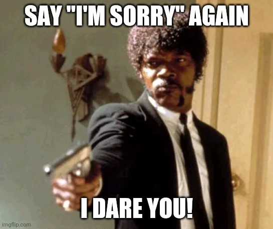 A man with a mustache and afro hairstyle, wearing a black suit and tie, points a handgun directly at the viewer. Behind him…