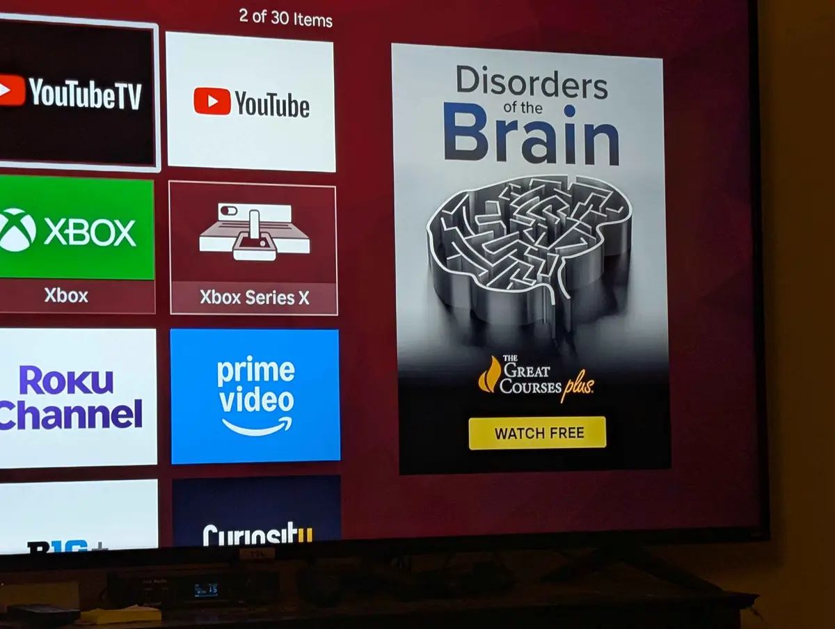 A TV screen shows a streaming interface with app icons like YouTube, Xbox, and Prime Video. A highlighted course titled…