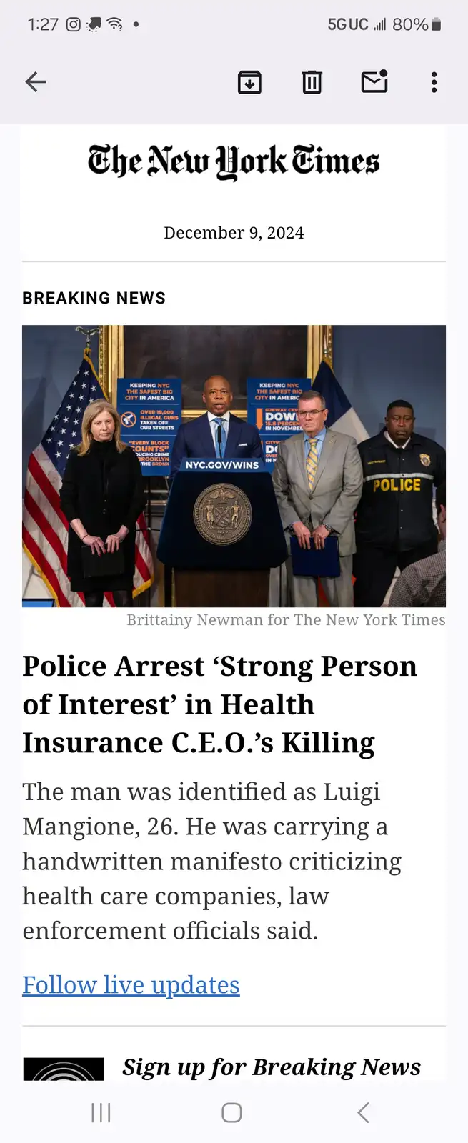 A screenshot of a New York Times breaking news article from December 9, 2024, featuring a photo of four officials at a press…