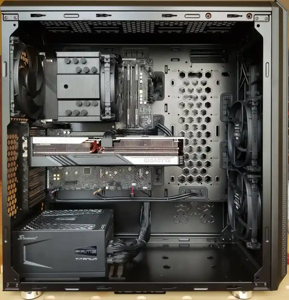 An overhead view of a custom-built PC case with its side panel removed, revealing a high-end internal setup including a…