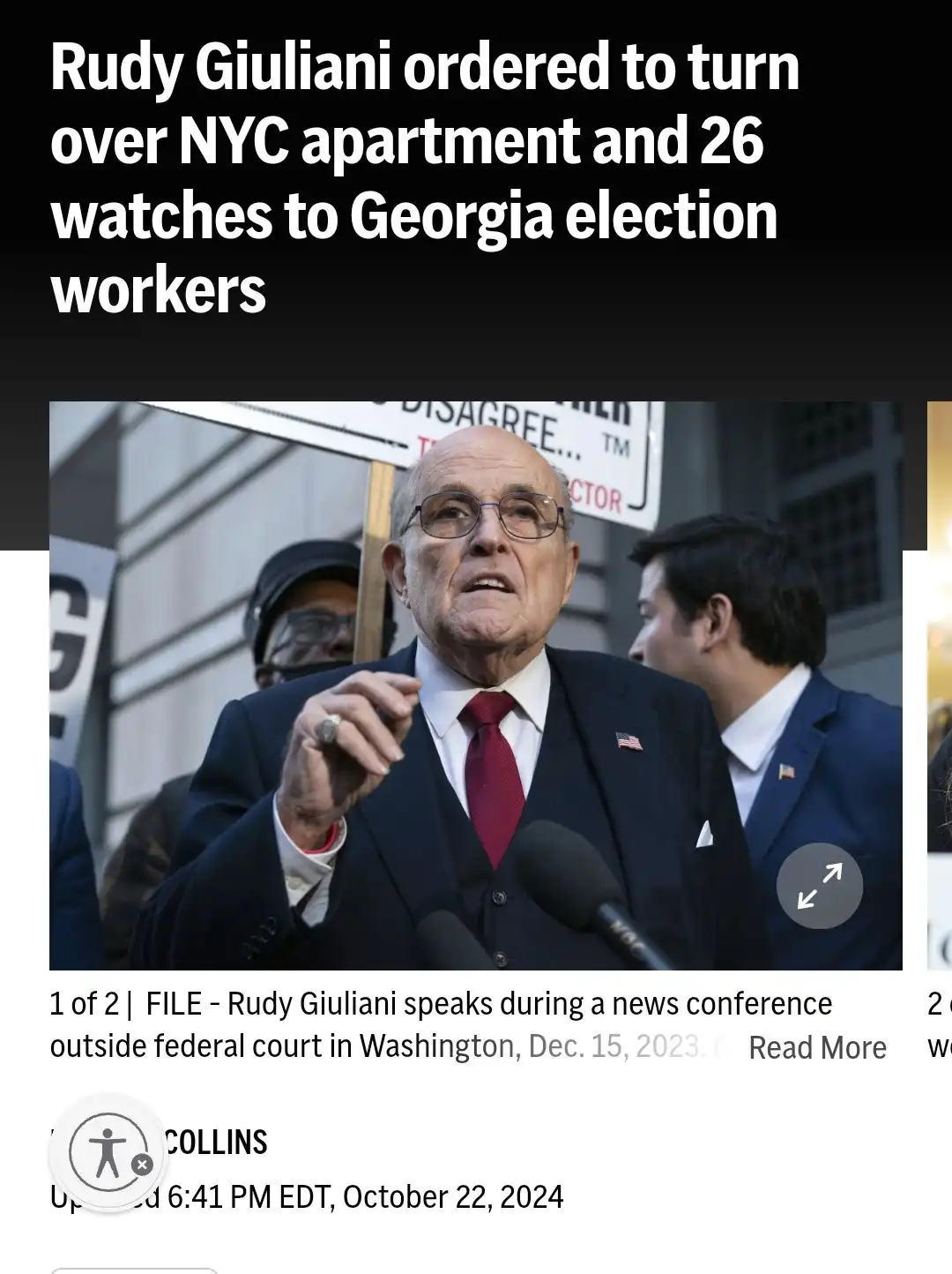 The image shows Rudy Giuliani speaking at a news conference, wearing a dark suit, red tie, and glasses, gesturing with his…