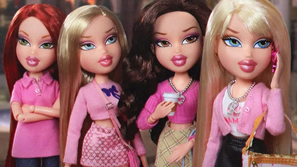 Four Bratz dolls in pink outfits stand together, one holding a coffee cup, another on a phone, all with exaggerated makeup…