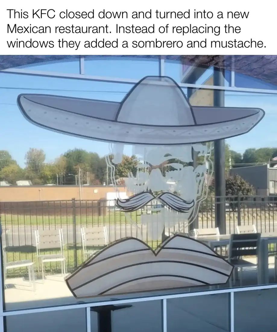 A photo shows a restaurant window with a large, cartoonish sombrero and mustache decal applied over the glass. The…