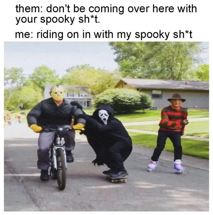 Three people in horror movie costumes are shown outdoors on a residential street. One person on a bicycle wears a Jason…