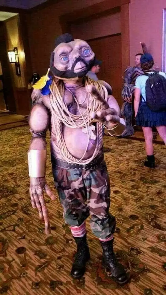 A person in a full-body costume resembling the alien character from 'E.T. the Extra-Terrestrial' stands in a hotel lobby…