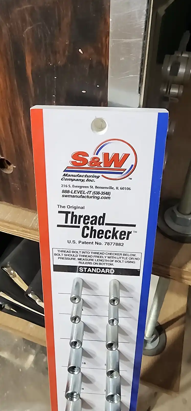 A close-up of an S&W Manufacturing Thread Checker tool, which has multiple threaded holes for measuring bolt thread quality…