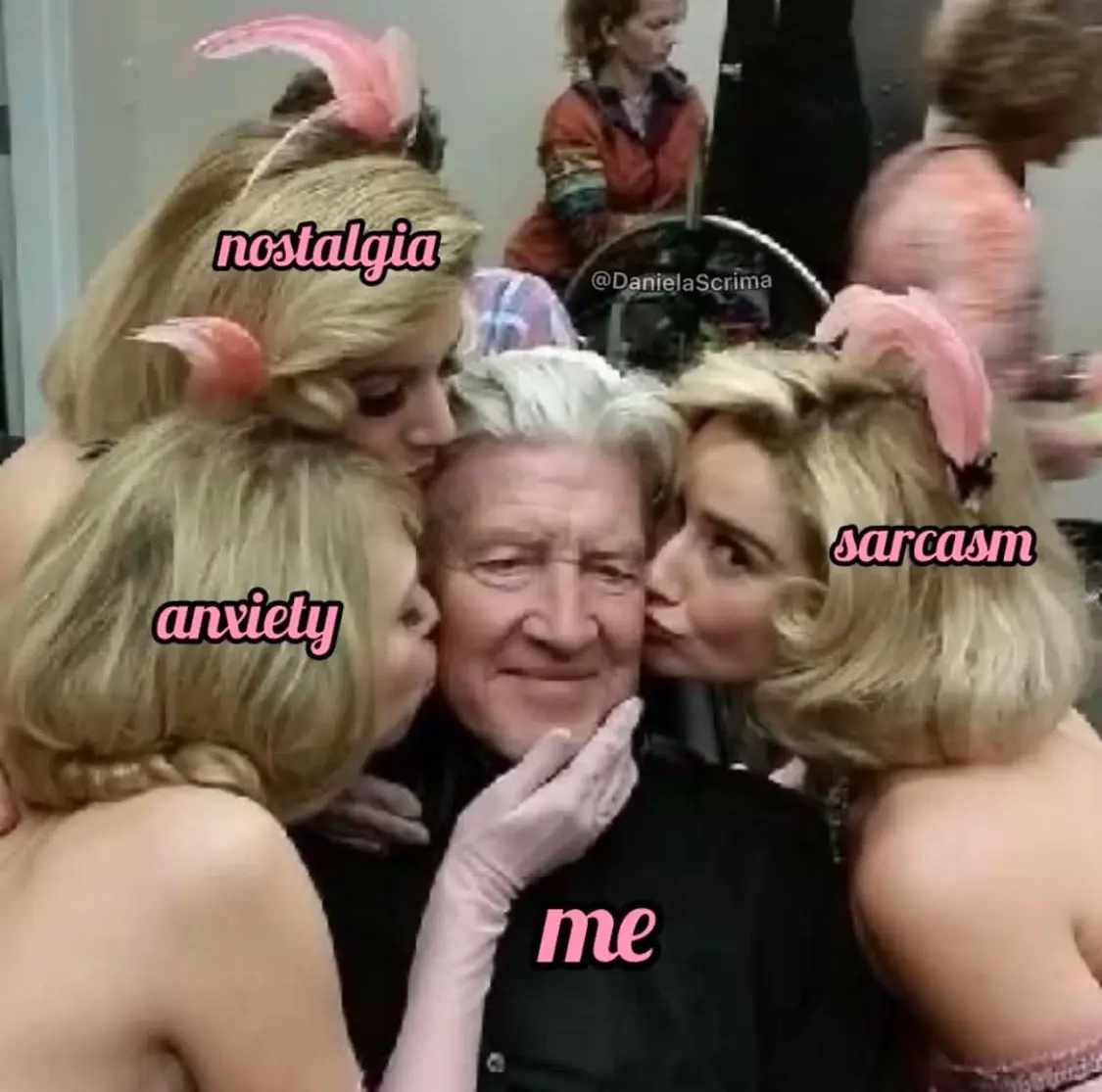 A man with white hair is surrounded by three women in vintage-style blonde hairdos and pink bunny ears, each kissing his…