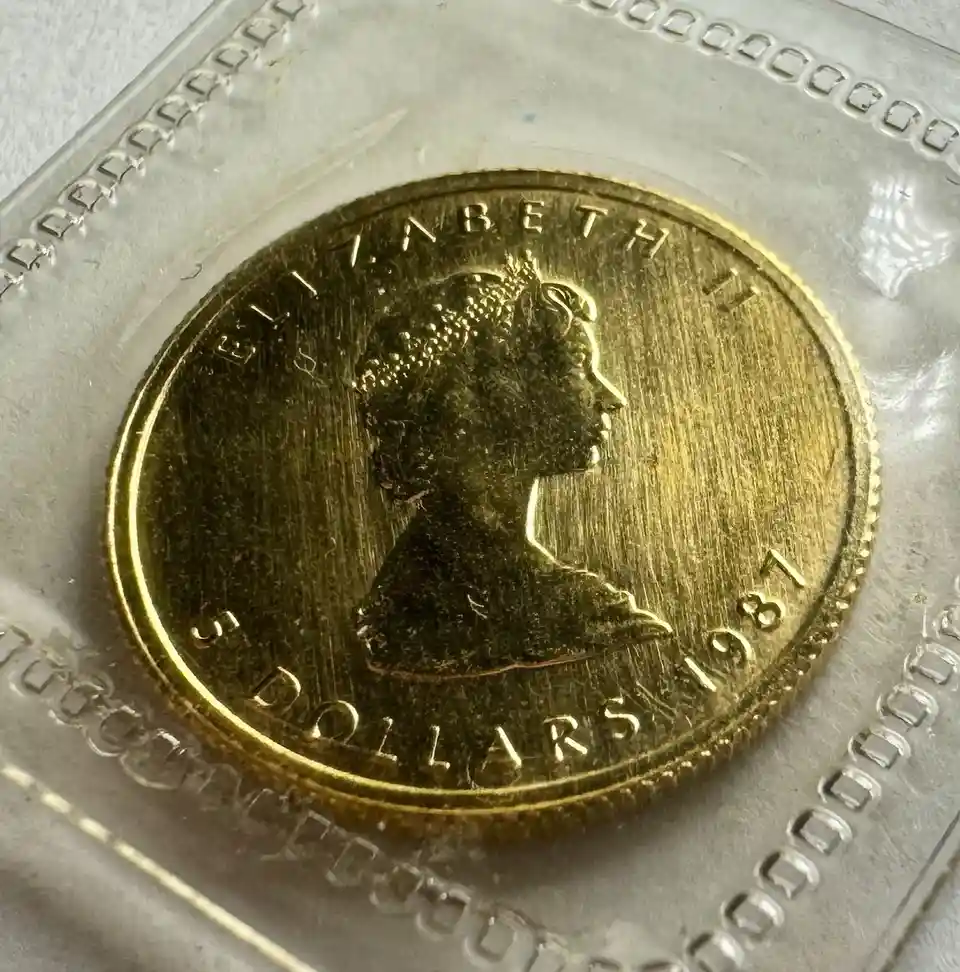 A close-up photo of a 1981 Australian five-dollar gold coin featuring Queen Elizabeth II's profile, encased in a clear…