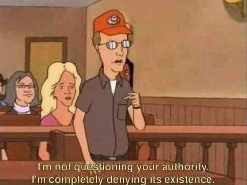 A cartoon man in a courtroom wearing a red cap and glasses stands with a smug expression, holding a cigarette. Behind him…
