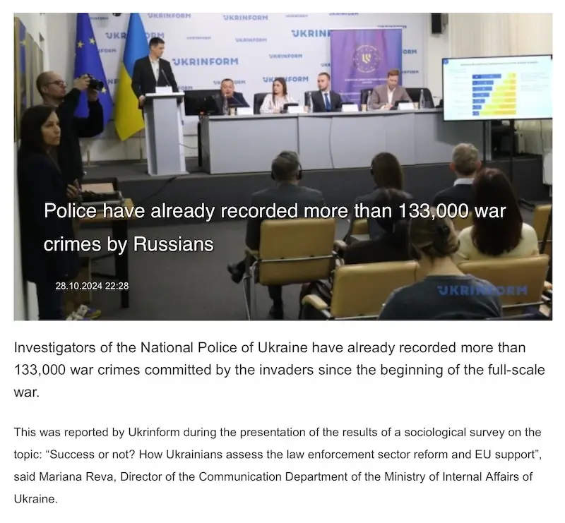 A screenshot from a Ukrainian government press conference shows a man speaking at a podium in front of a panel of officials…