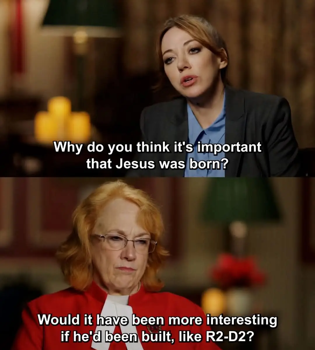 The meme features two panels from a TV interview. The top panel shows a woman in a dark blazer and blue shirt asking, 'Why…