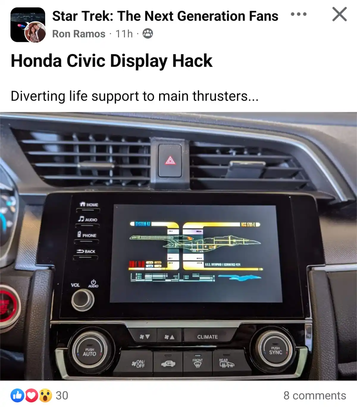 A close-up of a Honda Civic's infotainment screen, which has been modified to display a Star Trek: The Next Generation-style…