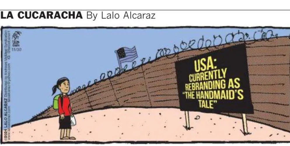 A cartoon depicts a young girl standing before a tall, barbed-wire-topped wall with an American flag on top. A large black…