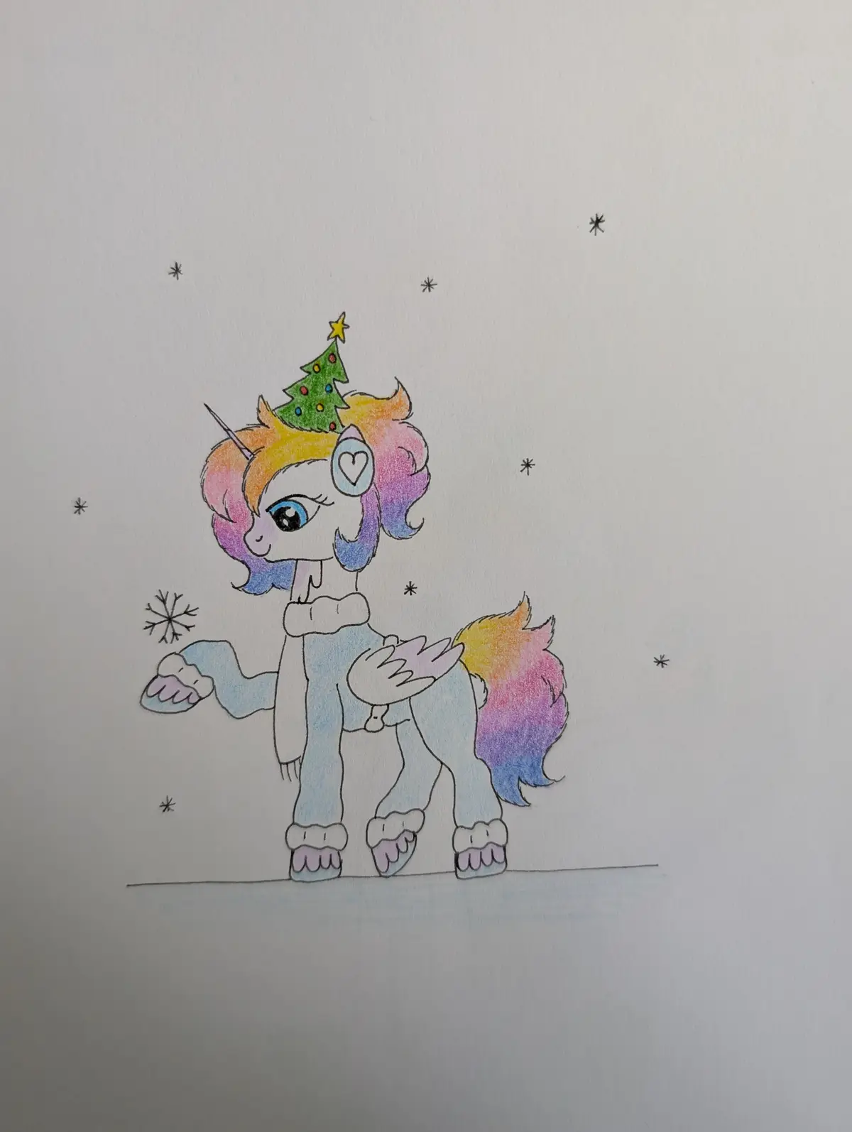 A hand-drawn cartoon unicorn with rainbow-colored mane and tail stands in a snowy scene, wearing a small decorated Christmas…