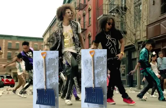 Two blue plastic shovels are superimposed over the midsection of two men in a street scene from the music video for 'Shovel'…
