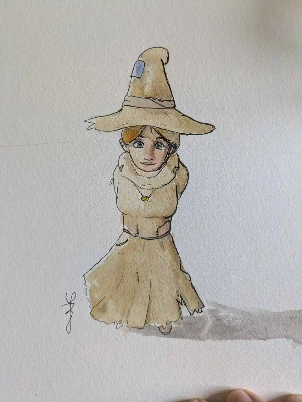 A watercolor drawing of a young girl with green eyes wearing a large, tattered witch's hat and a patched, beige outfit. The…